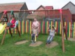 CSP children playing on a swing just outside their house. 