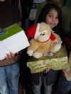 One of the Ioji children show off her Christmas teddy bear